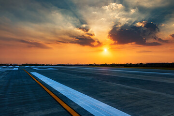 Runway, airstrip in the airport terminal with marking in sunset background. Travel aviation concept. - 364239987