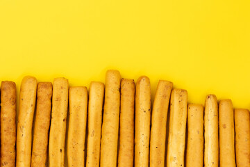 Grissini, Italian breadsticks isolated on yellow background