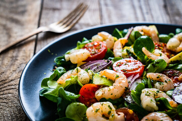 Prawn salad on wooden table
