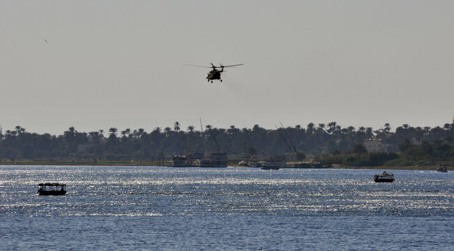 The Egyptian Air Force Helicopter Flies Upstream Along The Nile River In The City Of Luxor. Egypt.