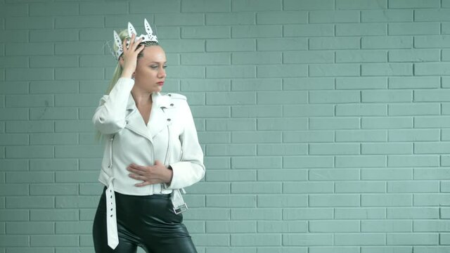 beautiful woman with afro braids in a leather white crown and a jacket. portrait