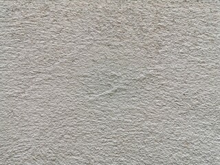 The rough surface of the cement wall is not painted.