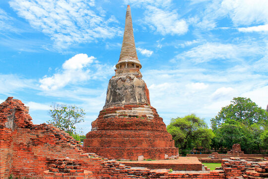 Old pagoda at wat mahathat ancient sites in ayutthaya province. Background beautiful cloud and blue sky.