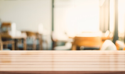 Empty wooden top table with blur coffee shop background