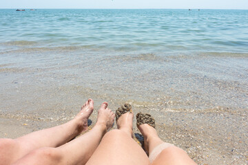 Legs in water.  women's feet in the clear water. summer concept
