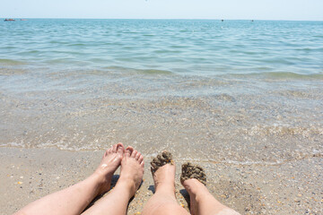 Legs in water.  women's feet in the clear water. summer concept