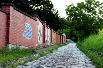 wall with graffiti and stone path