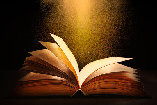 Open book on a dark background with magic fairy light coming from above and illuminating book pages