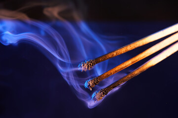 Lit matches and blown out in the studio photographed with colorful foils before the flashes