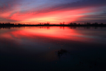 Naklejka na ściany i meble Colorful sunset by the Odra River, Poland.