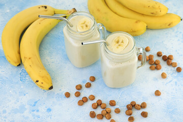 Banana yogurt or smoothie with banana slice and nuts, vegetarian food, diet concept