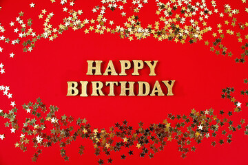 Fototapeta premium Text Happy birthday laid out of gold letters on beautiful background. Golden stars confetti.