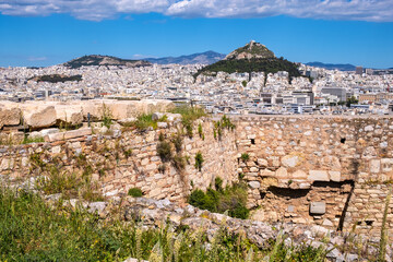 Fototapeta na wymiar Panoramic view of metropolitan Athens, Greece with Lycabettus hill seen from rocky top of Acropolis hill