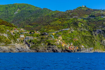 A view from the sea towards the Cinque Terre village of Riomaggiore, Italy in the summertime