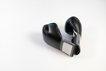 Black boxing gloves on a white background look visually like a heart