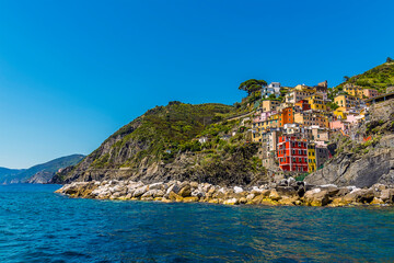 A view down the coastline from the Cinque Terre village of Riomaggiore, Italy in the summertime