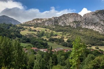 Small village in the mountains of the Pyrenees on the background of the cliff.