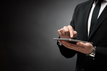 Businessman tapping finger at tablet screen