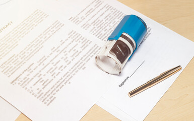 signing and stamping the contract to conclude a deal concept. pen and space for signature in...
