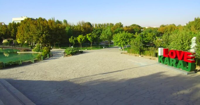 Karaj. IRAN. Hamoon Park, "I love Karaj" symbol inside the park and the stairs and pond and bridge on it, PAN view C398