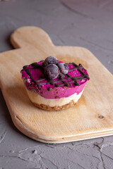 black currant cake on wooden board. Close up, no sugar concept