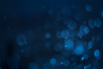 abstract sparkle bokeh light effect with navy blue background © DEEP PIXEL