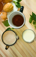 cups with milk, compote, coffee, flat lay