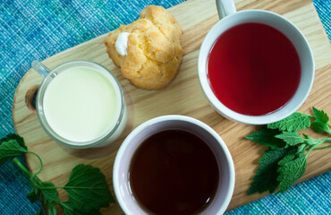 cups with milk, compote, coffee, flat lay