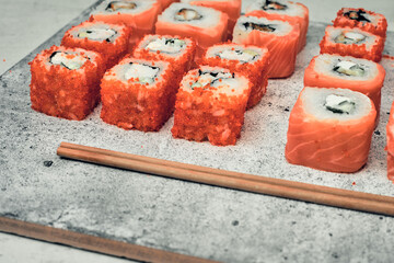 Traditional Japanese food, sushi and rolls. Ginger and wasabi, Chinese sticks. Rice and seafood food. Close up