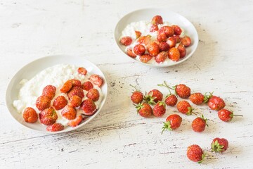 Healthy breakfast. Diet curd with fresh strawberries on a white vintage table.