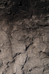 background texture of the walls are covered with grey cement mortar with a rough surface are not aligned and annealed in black surface