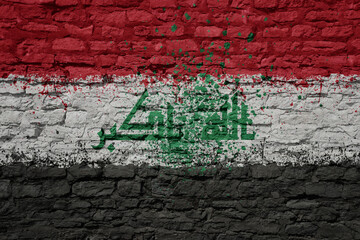 painted big national flag of iraq on a massive old brick wall