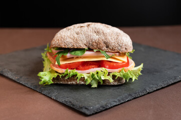 Sandwich on a slate board. Sandwich from the menu.