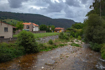 Fototapeta na wymiar A village in the mountains of the Pyrenees on the banks of a mountain river.