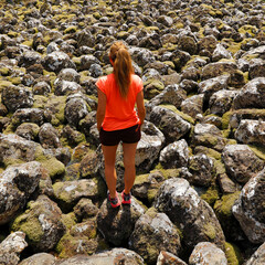 woman walking in old lava flow , calardez