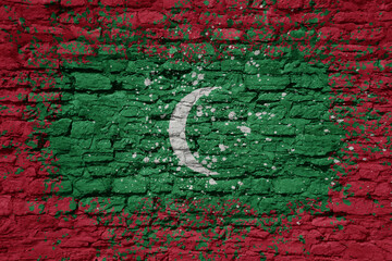 painted big national flag of maldives on a massive old brick wall