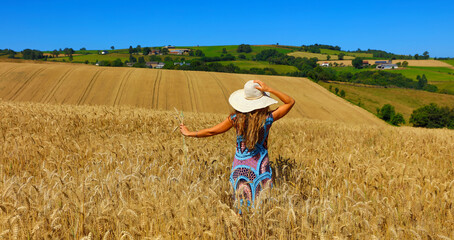 woman with wheat ear in hand on wheat field © M.studio
