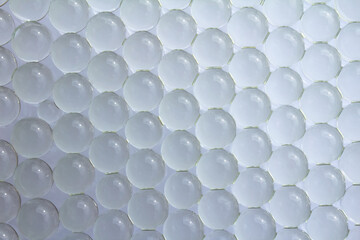 Macro of white gel balls. Abstract clean light geometric hydrogel background