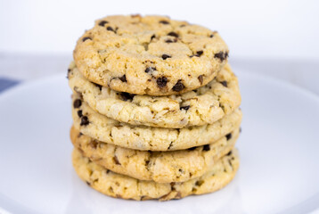 fresh baked classic chocolate chip cookies with nuts on a plate