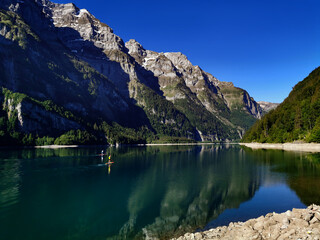Sport and standup paddle activities on Swiss mountain lake. Out