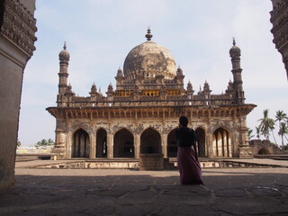 Fototapeta premium Beautiful building and a woman, Ibrahim Rauz, Bijapur, Karnataka, South India, India