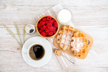 Breakfast in the morning with black coffee cup with bread with Croissant and fruit on the wooden table.