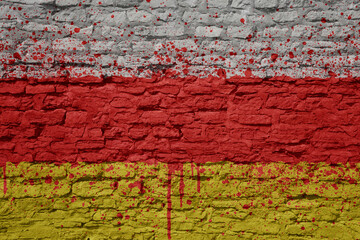 painted big national flag of south ossetia on a massive old brick wall