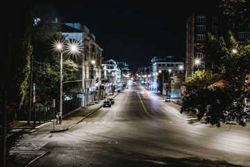 view of the evening and night streets of the city with cars people and beautiful buildings