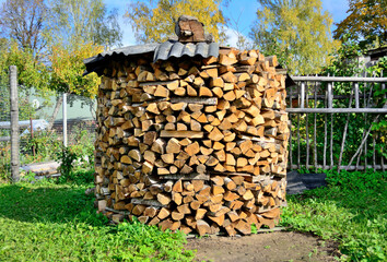 Firewood stacked for drying in the summer.