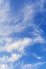 White clouds in beautiful deep blue sky background, vertical image
