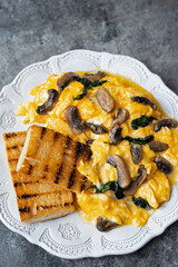 creamy scrambled eggs with mushrooms and spinach