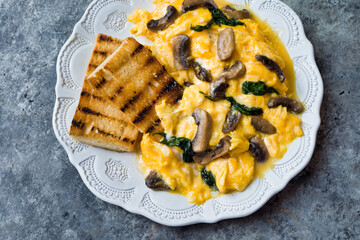 creamy scrambled eggs with mushrooms and spinach
