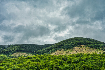 Fototapeta na wymiar cloudy rainy sky over hill