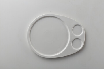 Top view shot of a rectangular white plate on white background.